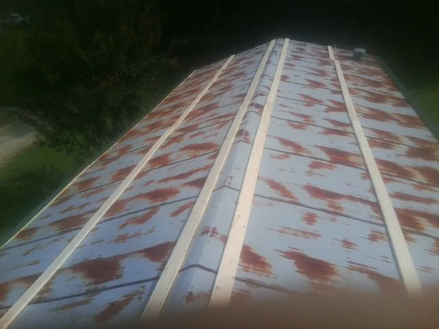 Rusted metal roof panels with new wood purlins before replacement — Storm Damage Roof Repair in Poolville by Roofing Brothers